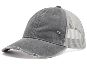 Close-up of distressed dark grey trucker hat with washed cotton and breathable mesh