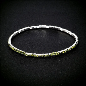 Detail view of 2.0mm silver bracelet with emerald cut yellow-green crystal stones