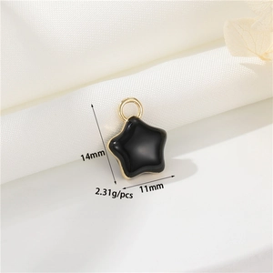 Macro detail of black and gold star pendant with 14mm height and 11mm width dimensions
