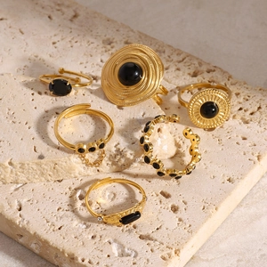 Vintage gold stainless steel rings set with natural black onyx stones on stone base