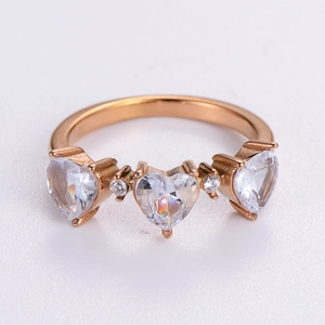Rose gold heart ring with three sparkling cubic zirconia stones on white background