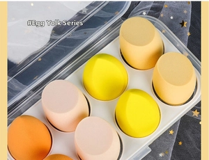 Detail of 8 yellow makeup sponge sets in a clear box with water drop and slant cuts