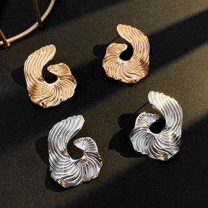 Irregular spiral wave earrings in gold and silver finish with retro metallic texture