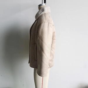 Detail of beige faux suede jacket with plush sheepskin fleece collar and warm lining