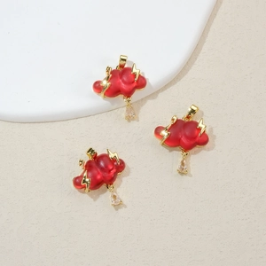 Detail of red cloud pendant with gold lightning and crystal drop on minimalist tray