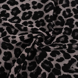 Close-up of leopard print mesh fabric with flocking texture and breathable net structure