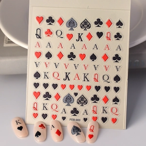 Detail of 5D embossed poker nail stickers with hearts and spades patterns