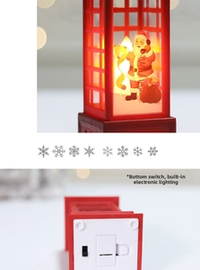 Detail view of red Christmas telephone booth LED light with battery compartment and switch