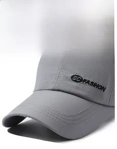 Detail of grey baseball cap showing reinforced wide brim and SC FASHION side embroidery
