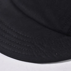 Macro shot of fine parallel stitching and high-density cotton twill fabric on hat brim