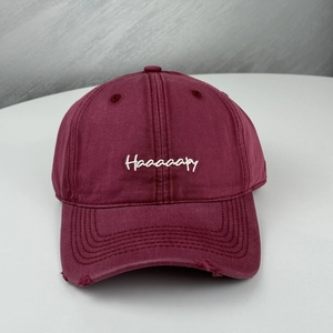 Burgundy vintage cotton baseball cap with Haaaaaapy embroidery and distressed brim detail