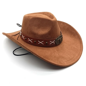 Detail of dark brown suede cowboy hat with bull head buckle and stitched leather band