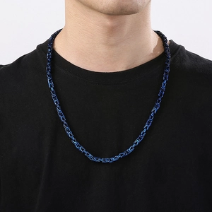 Detailed close-up of a 6mm deep blue stainless steel Byzantine chain on a male model