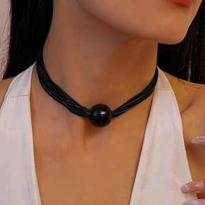 Close-up of a stylish black multi-strand choker with a large polished center bead