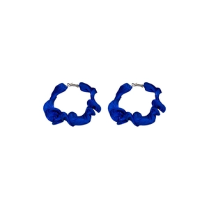 Minimalist blue fabric pleated hoop earrings with silver needles on a white background