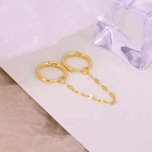 Macro shot of S925 sterling silver stamp on golden double hoop chain link earrings