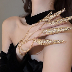 Detailed close-up of exotic gold hollow flower nail ring set with connection chains