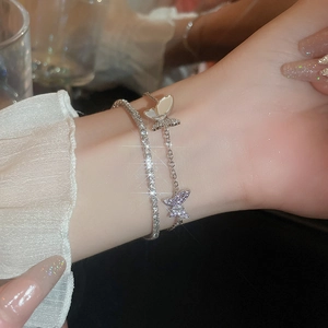 Close-up of double-layer zircon butterfly bracelet with sparkling tennis chain on wrist