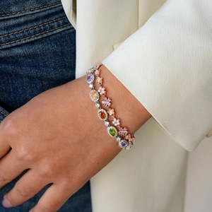 Luxury stackable bracelets with colorful oval gemstones and flower pearl details on wrist