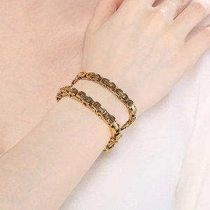 Golden Byzantine style stainless steel chain bracelet 6-piece set shown on model wrist
