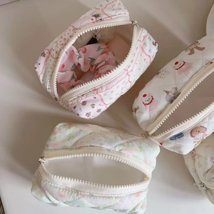 Close-up of quilted cotton makeup bags with cute cartoon and floral patterns