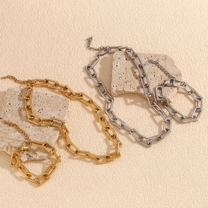 Detailed view of 18K gold and silver chunky chain necklace and bracelet jewelry set