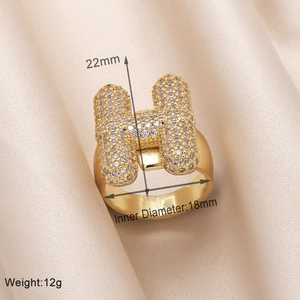Detailed view of gold-plated H letter ring with pave cubic zirconia and size dimensions
