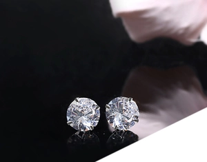 Detailed view of round-cut cubic zirconia stud earrings with a 4-prong silver setting