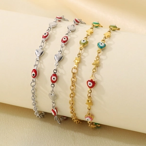 Detail of 18K gold and silver plated evil eye anklets with heart and star charms
