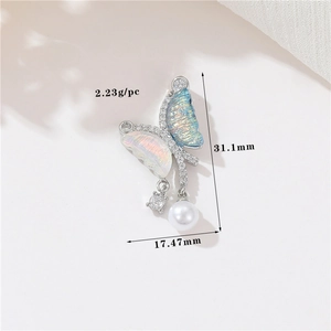 Macro shot of 14k silver butterfly pendant with blue-pink crystals and pearl, 31x17mm