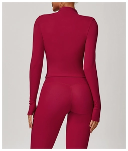 Rear view of wine red slim fit long sleeve yoga top with thumb holes and matching leggings