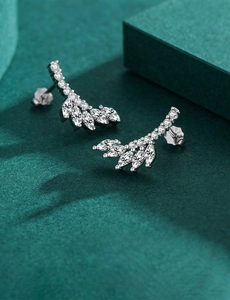 Macro shot of S925 sterling silver wing earrings with marquise-cut clear cubic zirconia