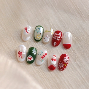 Christmas themed embossed press-on nails with red green snowmen and snowflake designs