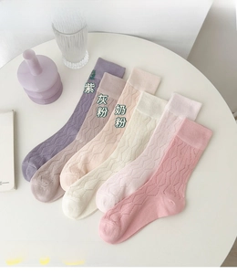 Detailed flat lay of six pairs of hollow knit cotton socks in assorted pastel pink shades