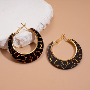 Detailed view of vintage resin hoop earrings with golden crackle pattern and metal lining