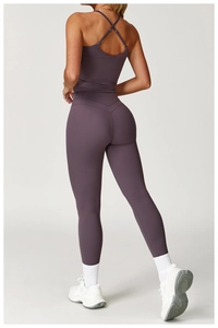 Rear view of purple cross-back yoga top and high-waisted leggings showing slim fit design