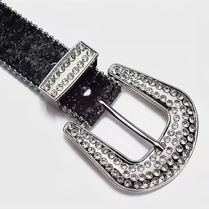 Women's black leather belt with silver buckle and sparkling rhinestones on white background