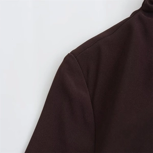Detailaufnahme der Schulternähte an einem dunkelbraunen Midikleid mit Faltenverzierung