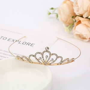 Detail of elegant gold rhinestone bridal crown with roses on a minimalist white surface