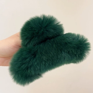 Detailed view of large dark green plush claw clip made of thick rabbit fur texture