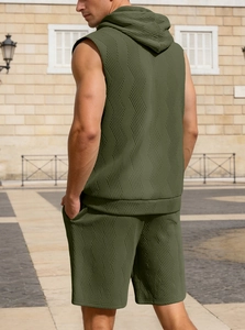 Detail of army green textured knit fabric on men's sleeveless hoodie and shorts set