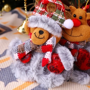 Close-up of plush Christmas bear and reindeer ornaments with knitted hats and faux fur