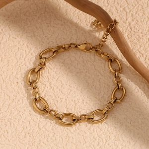 Detail of 14K gold plated stainless steel chunky oval link chain bracelet on a branch
