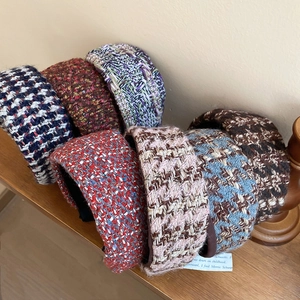 Multiple French style tweed headbands in various colors showing thick wool texture