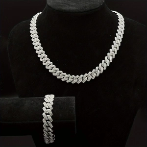 Macro shot of silver Cuban link chain necklace and bracelet set with full rhinestone inlay