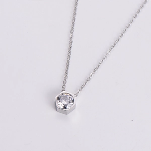 Macro view of a hexagonal pendant necklace with a brilliant round-cut cubic zirconia stone