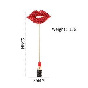 Fashion red lips and lipstick brooch with tassels and rhinestones on white background