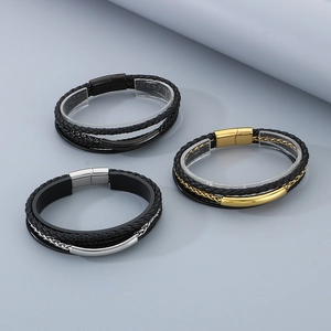 Macro detail of multi-layer leather bracelets with magnetic clasps in gold and silver
