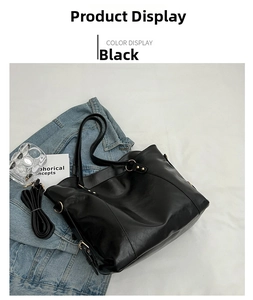 Detail of a black large-capacity tote bag with detachable strap on a denim jacket