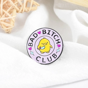 Round purple enamel pin with a cartoon chick and Bad Bitch Club lettering